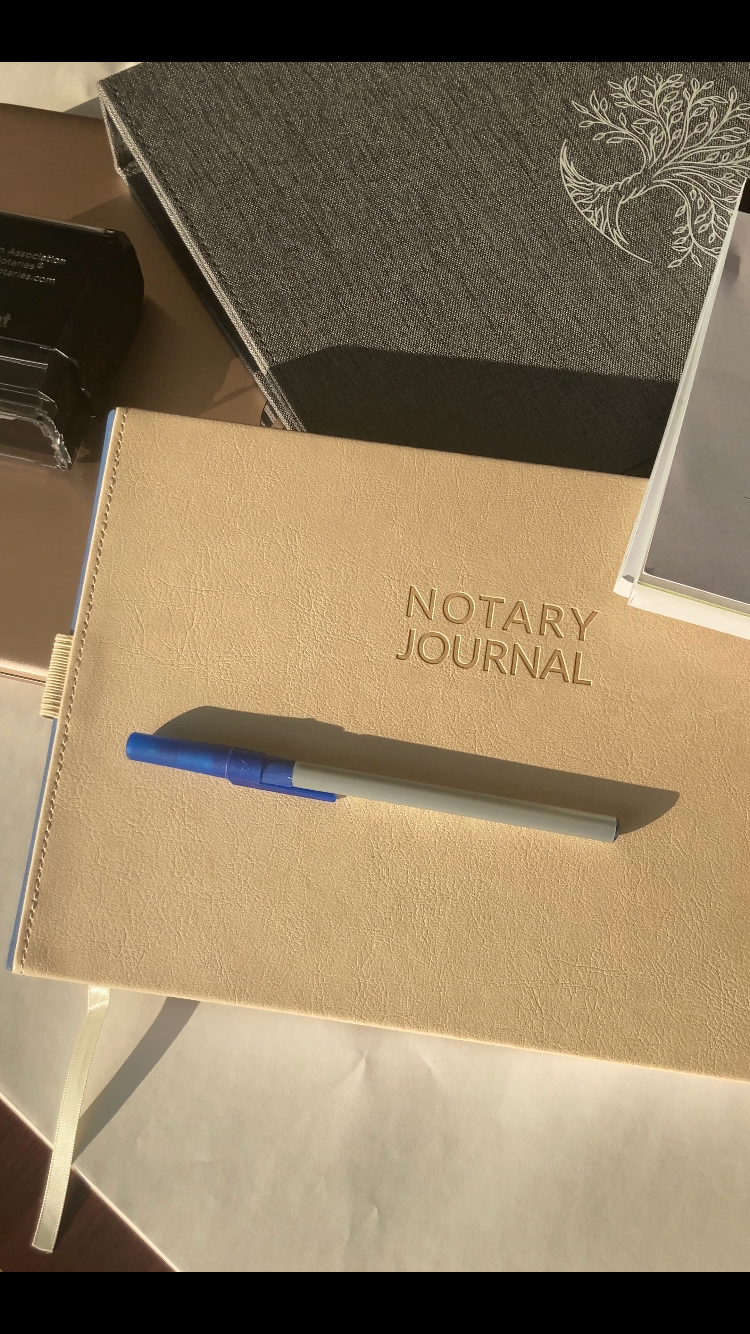 a notary journal with a pen sitting on top of it. Notary Public Omaha Nebraska, Notary Public Lincoln Nebraska, Notary Public Gretna Nebraska, Notary Public Nebraska